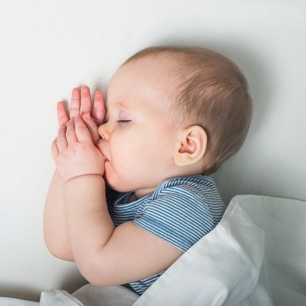 a baby sleeps soundly in its cradle