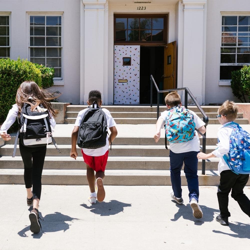 elementary age kids enter a school building.jpg